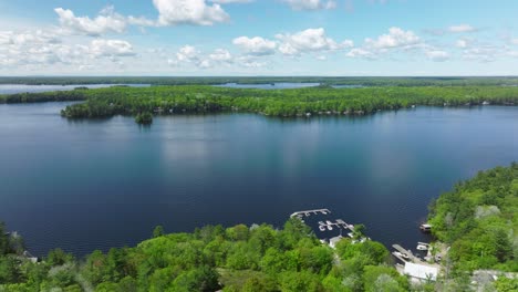 Lake-Muskoka-with-a-small-harbor-during-sunny-day,-Ontario,-Canada
