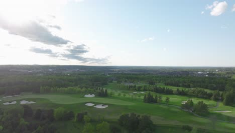 Golf-pitch-in-Aurora,-Ontario,-Canada-in-may,-panorama-on-the-city-from-a-drone,-Drone-rising-up