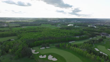 Golf-pitch-in-Aurora,-Ontario,-Canada-in-may,-panorama-on-the-city-from-a-drone,-Drone-flying-forward
