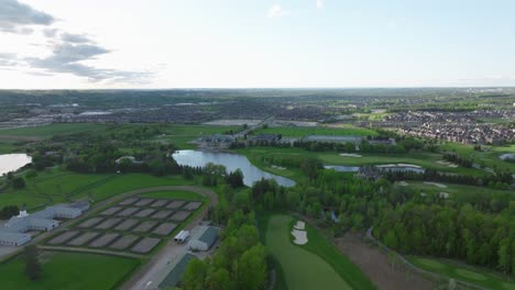 Golf-pitch-in-Aurora,-Ontario,-Canada-in-may,-panorama-on-the-city-from-a-drone,-Drone-flying-forward-part-2