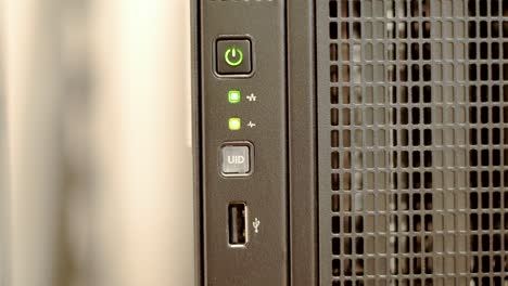A-green-network-indicator-light-blinks-sporadically-on-a-black-tower-server