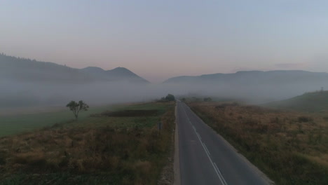 a-road-to-a-misty-field-in-a-mountainous-area