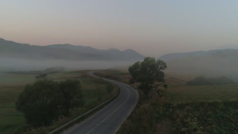 a-road-to-a-misty-field-in-a-mountainous-area