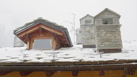 Panning-camera-view-of-fireplaces-under-a-snowing-day-from-hotel-window