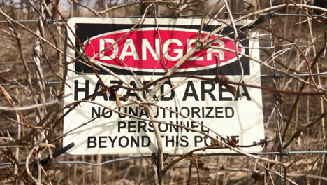 Sign-on-fence-indicates-Danger-Hazards-Area
