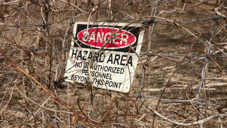 Sign-on-fence-indicates-Danger-Hazards-Area