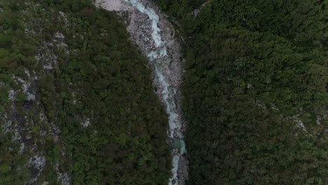 Aerial-Drone-Shot-of-a-River-surrounded-by-a-Forest-in-Slovenia,-4k-UHD