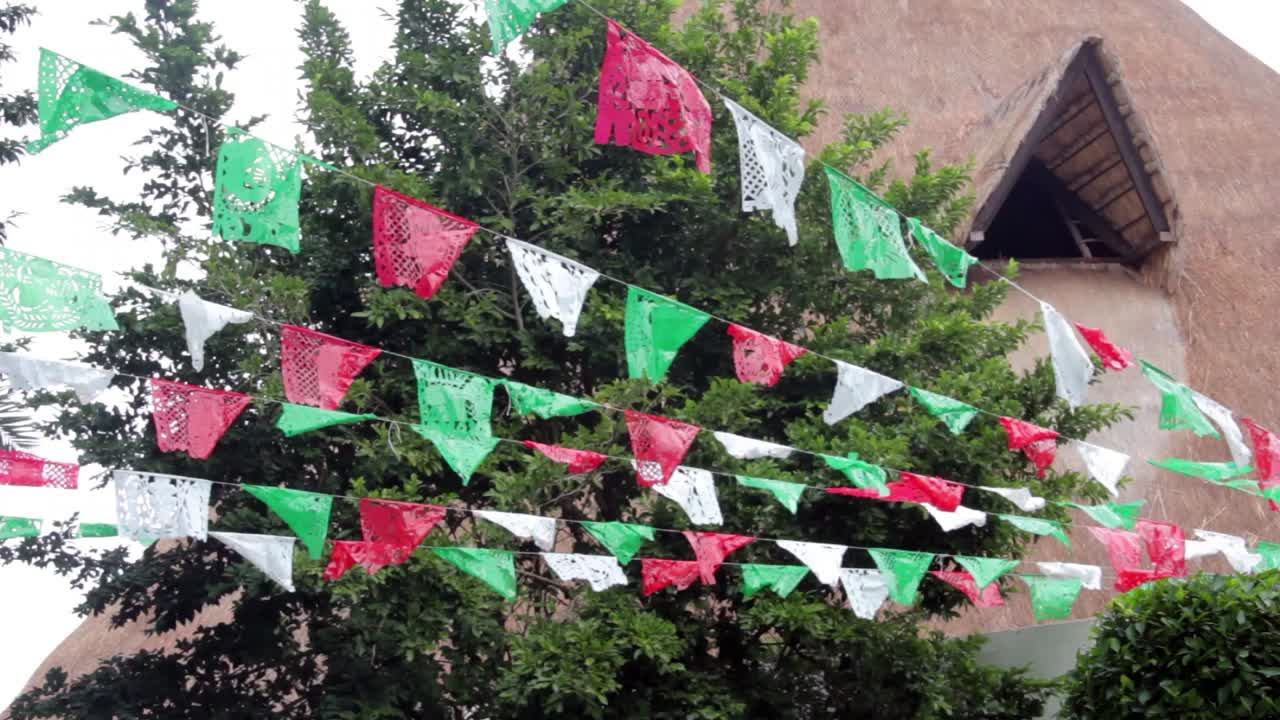 Premium stock video - Mexican fiesta flags moved by wind