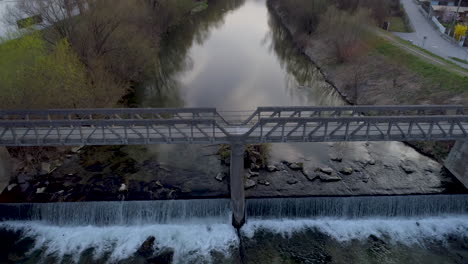 Aerial-Drone-Shot-of-a-Bridge-over-a-River-at-Sunset,-4k-UHD