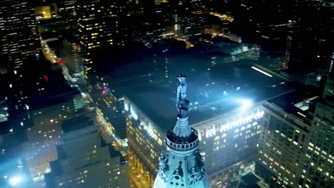 Incredible-aerial-coverage-of-the-William-Penn-statue-that-sits-a-top-City-Hall-in-downtown-Philadelphia,-PA