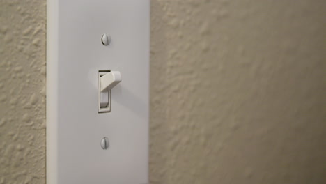 Man's-Hand-Turns-Light-Switch-Off-then-On
