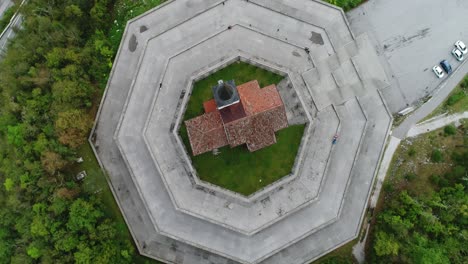 Circling-aerial-drone-shot-of-a-church-in-Slovenia,-flying-up,-4k-UHD