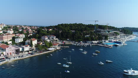 Aerial-Drone-Shot-of-an-old-Village-next-to-the-Sea-with-small-Boats,-4k-UHD