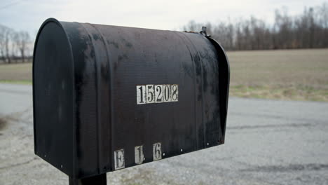 Close-Up-of-Old-Abandoned-Mailbox-on-Country-Road