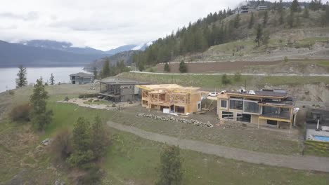 An-aerial-Drone-shot-of-a-house-overlooking-a-lake-being-constructed