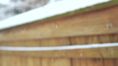 Snow-Falling-Against-Fence-in-Slow-Motion---Close