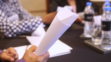Male-hands-holding-sheet-of-paper