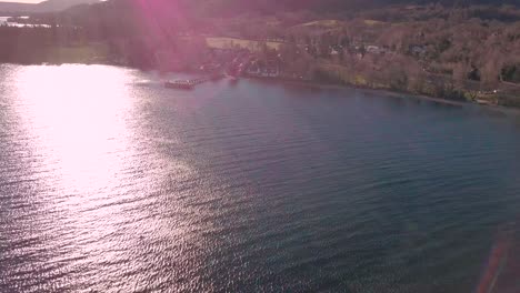 Aerial-shot-over-loch-lomond-in-Scotland-filming-Luss-during-golden-hour