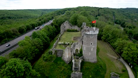 Aerial-Panning-View-of-Normandy-France-Castle-in-Forest-next-to-freeway