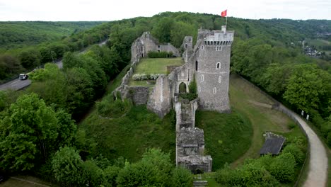 Pull-back-Aerial-View-of-Chateau-Ruins-in-French-countryside-next-to-freeway