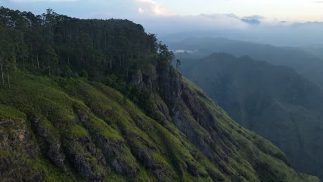 Aerial-drone-shot-along-the-hilly-slope-leading-upto-Ella-rock-viewpoint-in-Sri-Lanka-during-sunrise