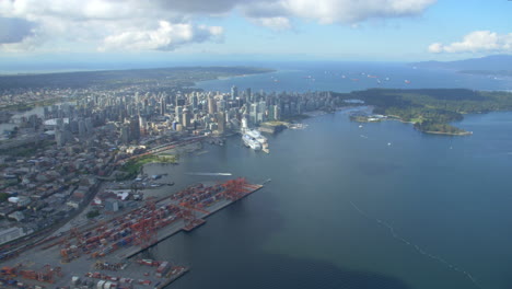 Downtown-Vancouver-and-BC-Place-Helicopter-shot-looking-west-towards-Coal-Harbour-and-Stanley-Park-in-British-Columbia