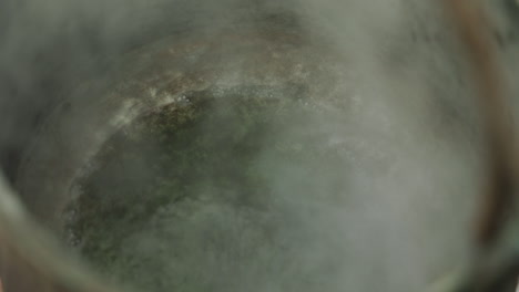 Boiling-steam-coming-out-of-a-which-kettle,-brewing-potion,-magical-scene-shot-in-closeup