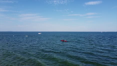 Aerial-tourists-kayaking,-paddling-on-the-Baltic-Sea