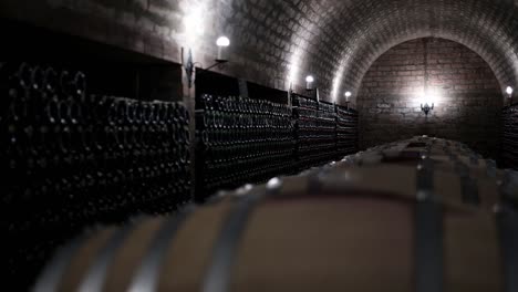 Luxury-underground-wine-cellar,-dark-wine-cellar-with-dim-lighting-and-wine-barrels-in-the-middle-of-the-room