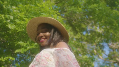 Black-Woman-walking-around-and-smiling-on-picnic-in-park-low-angle