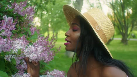 Black-Woman-smelling-flowers-Lilacs-Close-up