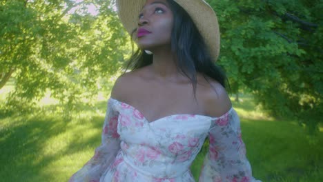 Black-Young-Woman-on-picnic-in-park-looking-up-tilt-close-up