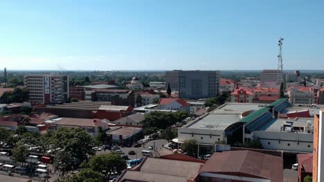 A-panning-drone-shot-of-Bulawayo,-Zimbabwe's-city-buildings-under-sunny-conditions