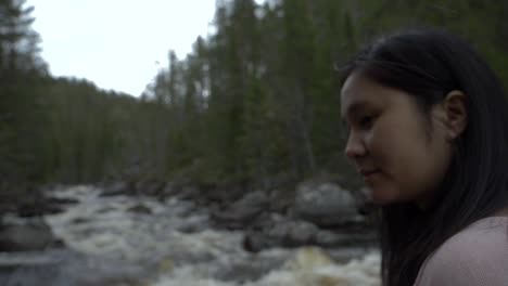 Girl-in-the-forest-by-a-river.-Slowmotion