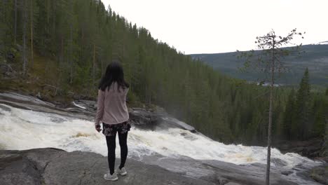 Girl-besides-a-waterfall-in-norway