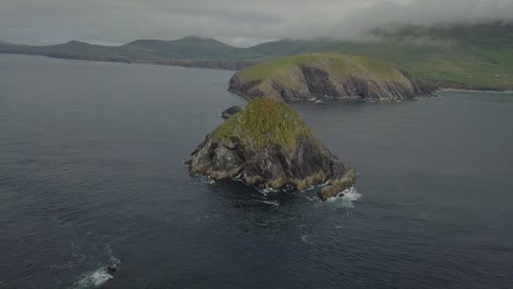 Schöne-Luftaufnahme-Von-Zerklüfteten-Felsformationen,-Die-Sich-Entlang-Des-Wild-Atlantic-Way-Von-Dunmore-Head-In-Irland-Bis-Zum-Meer-Erstrecken