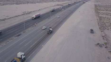 Desert-Highway-Traffic-Aerial-Footage---Fly-Backwards