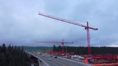 Crane-by-busy-highway-bridge-construction-zone