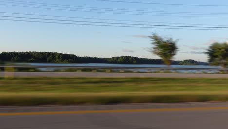 Footage-during-car-movement-near-large-lake