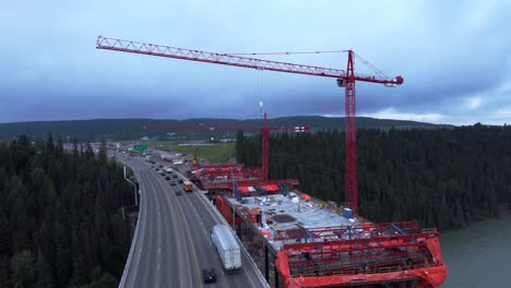 Crane-workers-on-bridge-construction-by-highway-bridge-trucking