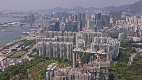 Aerial-drone-rotating-shot-over-Laguna-City,-revealing-Kwun-Tong-Typhoon-Shelter-along-the-bay-area-in-Hong-Kong,-China-on-a-sunny-day