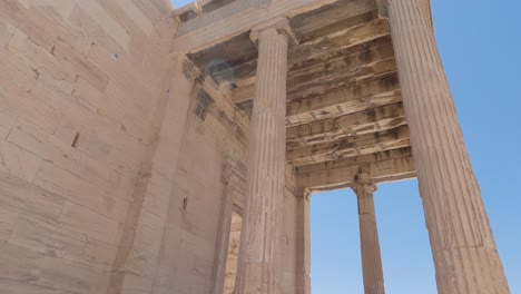 Tilt-down-from-Scenic-Pandroseion-entrance-columns,-Historical-site-At-Acropolis-of-Athens,-Greece