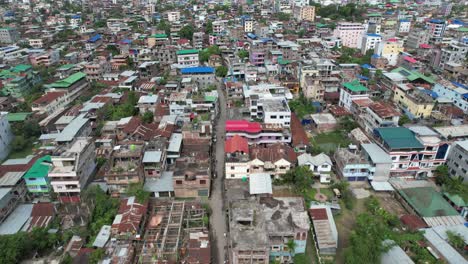 Aerial-Shot-Of-Slums-House-With-Mountains-In-Background,-India