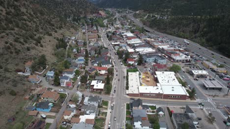 Aerial-View-of-Idaho-Springs,-Colorado-USA-and-Traffic-on-Interstate-70-Highway,-Drone-Shot