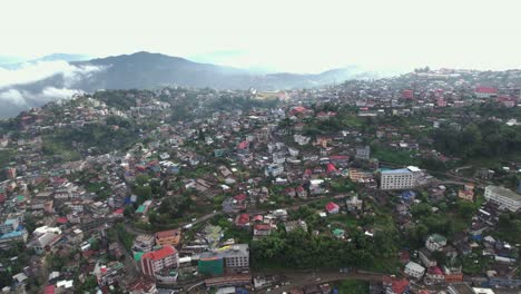 Aerial-shot-of-house-on-hills-all-around-Kohima-in-Nagaland,-India