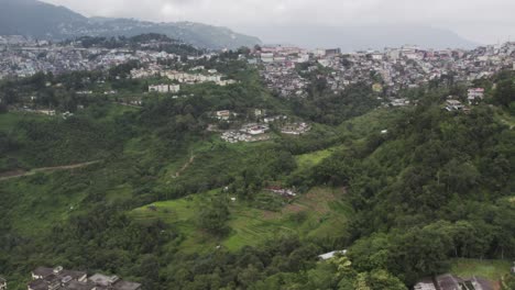 Aerial-Shot-Of-House,-Building,-And-Trees-On-The-Mountain-In-Kohima,-India