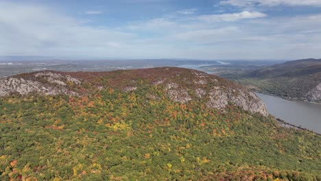 An-aerial-view-high-over-the-mountains-in-upstate-NY-during-the-fall-foliage-changes,-on-a-beautiful-day