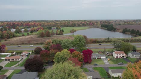 Drone-footage-of-lakeside-and-small-town-during-autumn