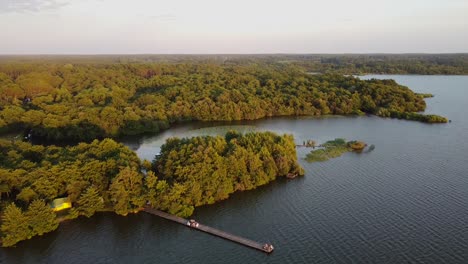 jetty-surrounded-by-forest-on-the-lake-of-soustons-in-the-french-landes-at-sunset-time