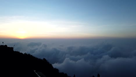 Sunrise-with-dancing-mist-cloud-evolutions-above-Kodaikanal,-Tamil-Nadu,-India